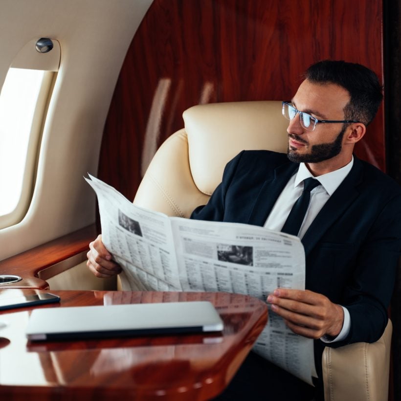 Business man flying on private jet